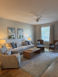 Your coastal retreat awaits with plush sectional seating, calming artwork, and gentle ceiling fan breezes for ultimate relaxation.