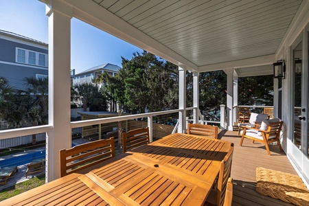 Relax on your private covered deck with teak furniture, overlooking the sparkling pool and tropical palms below.
