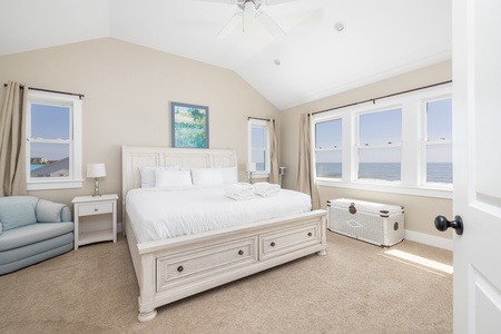 Wake up to breathtaking ocean views in your serene bedroom with its crisp white linens and coastal charm.