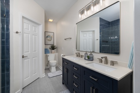 Your primary bedroom features a dual vanity and stunning tile accents