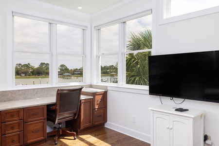 Settle into your waterfront workspace, where large windows frame peaceful water views and natural light fills the room—perfect for staying productive or simply unwinding.