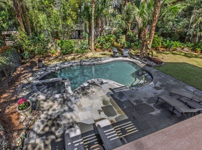 Your private backyard oasis awaits with a sparkling pool, spa, and lush tropical landscaping for ultimate relaxation.