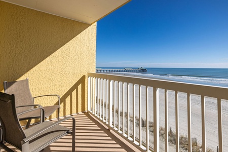 Step onto your private balcony and breathe in the ocean air while watching waves roll toward the sandy shore and fishing pier.