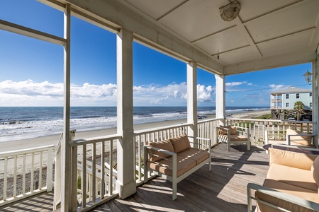Your covered porch overlooks the sand and waves