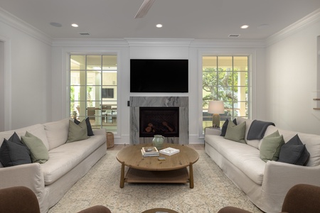 Your living room features premium furnishings and two large windows for natural light