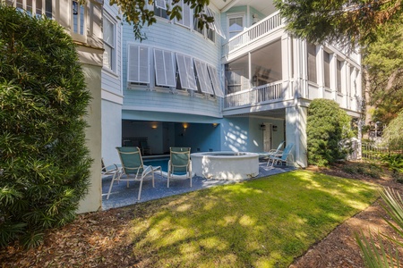 Step around back to your private pool, featuring comfortable loungers and an elevated hot tub