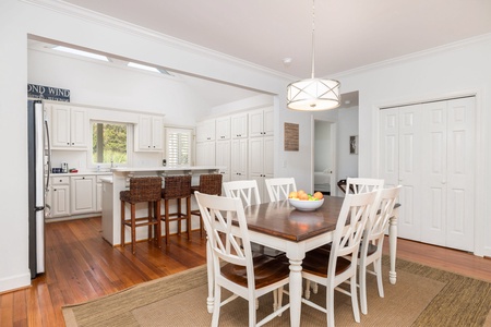 Just off the kitchen is your large dining area featuring a whitewashed farmhouse table and elegant lighting