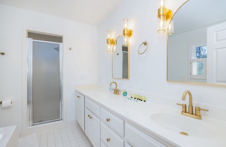 Your upstairs primary bedroom features an en suite bathroom with a dual vanity and jacuzzi tub