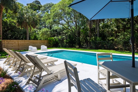 Lounge poolside in your private backyard oasis