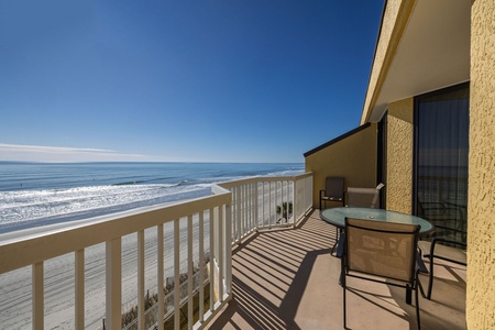 Beachfront balcony with panoramic ocean views, perfect for morning coffee watching waves roll in.