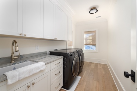 Your beautifully appointed laundry room features premium appliances and elegant marble counters, making household tasks feel luxurious.