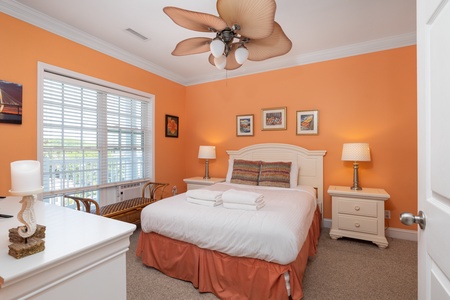 Your queen bedroom is a vibrant coastal retreat