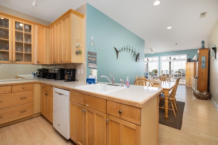 Warm wood cabinets and coastal decor create the perfect beachside cooking experience