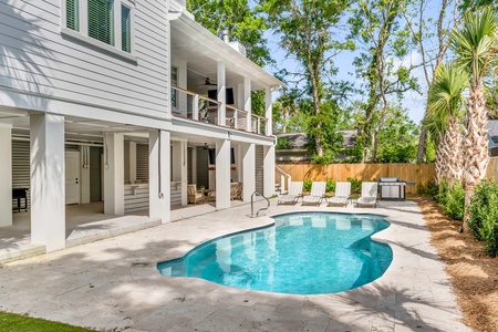 Dive into your private oasis with a sparkling pool surrounded by lush palms and comfortable loungers