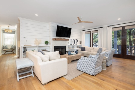 Your living room features large sofas, armchairs, and a stunning fireplace