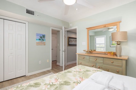 Drift off in your peaceful bedroom, featuring coastal-inspired decor, built-in storage, and gentle natural light filtering through plantation shutters.