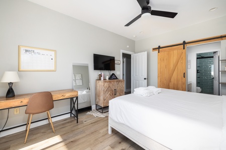 This king bedroom has sliding glass doors that lead straight to the back deck
