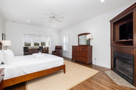 Your peaceful retreat features a plush bed, warm fireplace, and seating area with outdoor views—perfect for unwinding after your adventures.