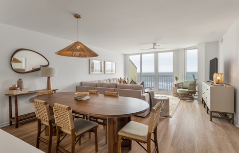 Unwind in this sophisticated living space where warm wood tones meet ocean views through floor-to-ceiling windows.