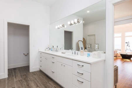 Dual vanities are ready for you in your primary en suite bathroom