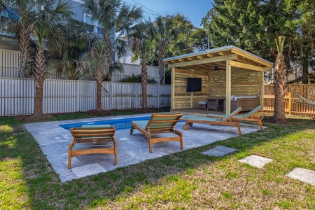 Soak up the sun beside your private pool, where comfortable loungers and a covered pavilion create the perfect tropical retreat.