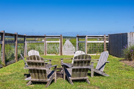 Gaze out over the marsh from your adirondack chairs