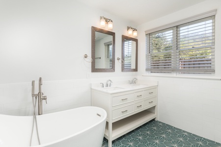 Your king en suite bathroom has a large soaking tub and glass walk-in shower