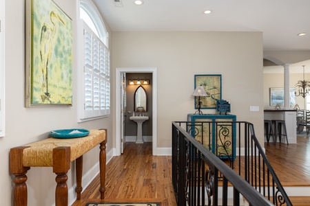 Enter the upstairs to your half bath and living room