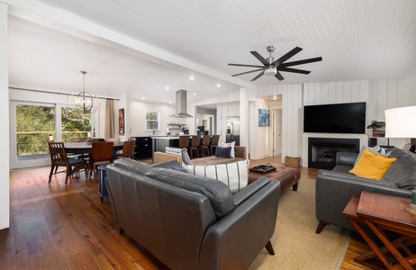 Bright, open living area with comfortable seating, coastal décor, and seamless flow to the kitchen and dining space.