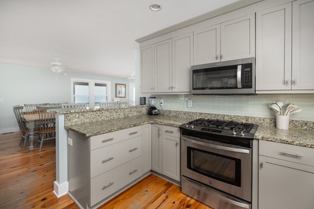 Your gourmet kitchen awaits with granite counters, stainless appliances, and stunning ocean views.