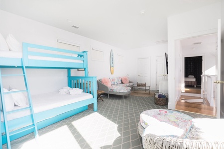 The bunk room has it's very own sitting area with a wall-mounted tv