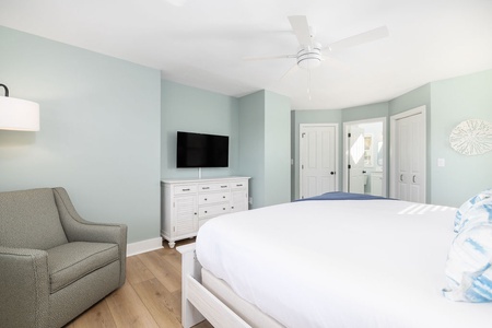 The primary bedroom has large windows to enjoy the marsh view.