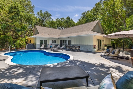 Easy Breezy features a sparkling backyard pool for relaxing al fresco
