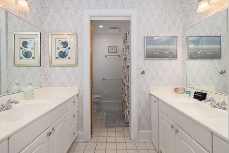 Hall bath with double vanity and tub shower combination