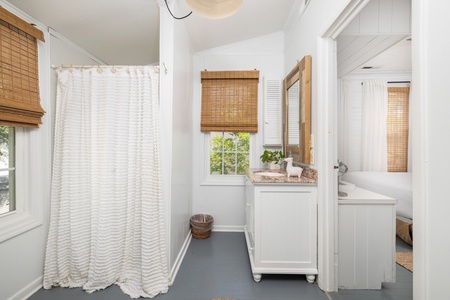The queen en suite has a tub-shower combo and a large vanity