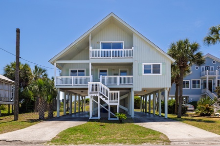 Emerald Cove is a coastal beach house on elevated stilts featuring spacious covered parking below
