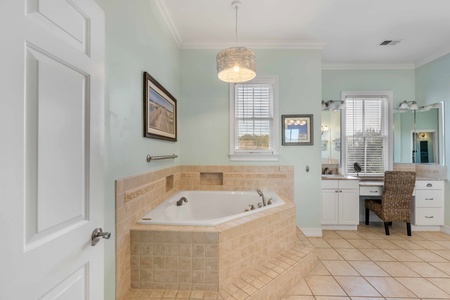 Unwind in your spa-like master bathroom with a deep soaking tub, elegant vanity space, and soothing coastal colors.