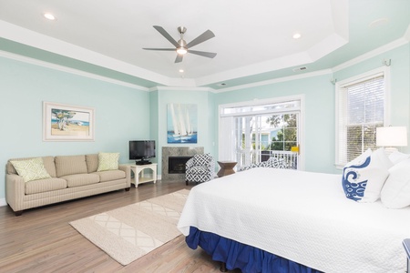 Your upstairs primary bedroom features cozy seating and a fireplace