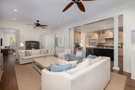 Your spacious open-concept living area features plush seating and ceiling fans.