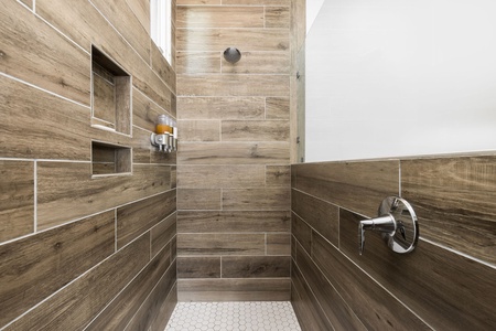Your luxurious walk-in shower has white hexagonal tiles