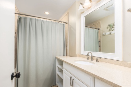 Your private bathroom features a spacious vanity with ample storage and a refreshing shower to start your day.