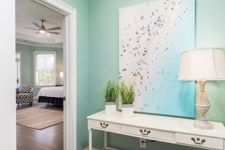 Pass the beach-themed artwork on your way to your upstairs primary bedroom