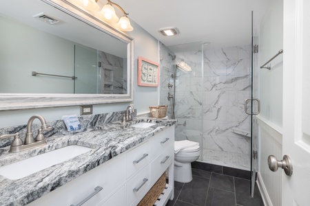 The king en suite bathroom has a walk-in shower and dual vanities