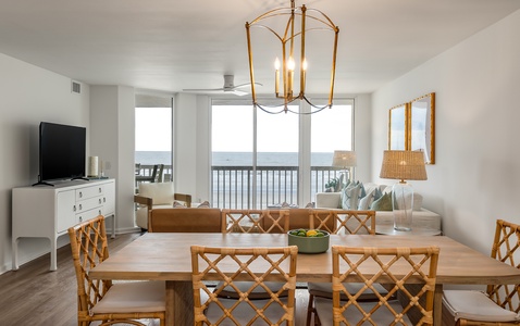 Gather around your elegant dining table while ocean waves shimmer beyond the balcony, creating perfect moments for memorable meals together.