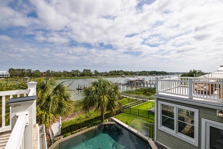 A stunning waterfront property featuring lush palm trees, serene river views, and private pool access. The perfect coastal retreat awaits.