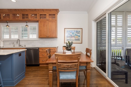 Your open kitchen and dining space features warm wood cabinetry, modern appliances, and a welcoming table where you can enjoy meals together while natural light fills the room.