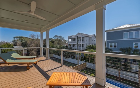 Your private balcony with teak furniture offers peaceful moments under ceiling fans with neighborhood views.