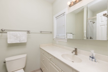 Fresh towels await in your pristine bathroom, complete with modern fixtures and thoughtful amenities for your comfort.