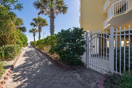 Lushly landscaped walkway leads you to the beach.