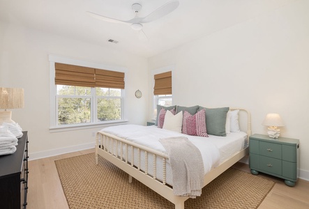 Drift off to sleep in your serene bedroom with crisp linens, natural light, and peaceful garden views through bamboo blinds.
